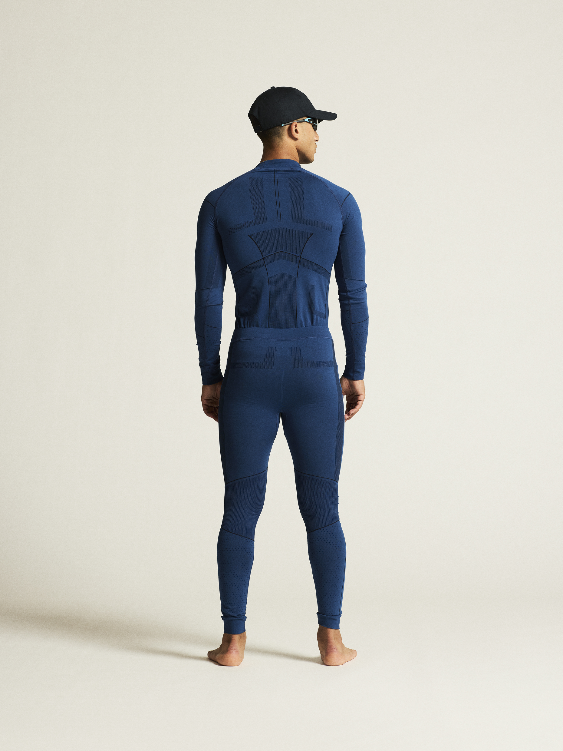 Man models blue thermal base layer top and bottoms.