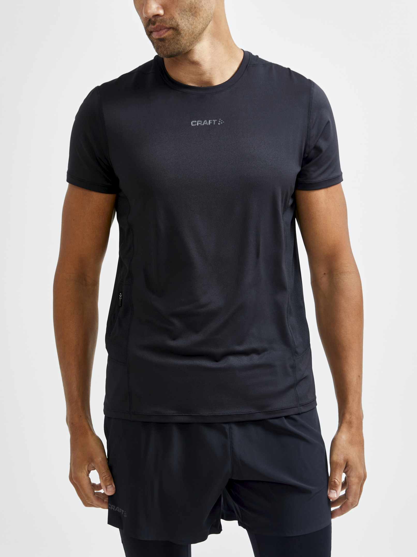 Man wearing a black Craft brand athletic t-shirt with mesh panels for breathability.