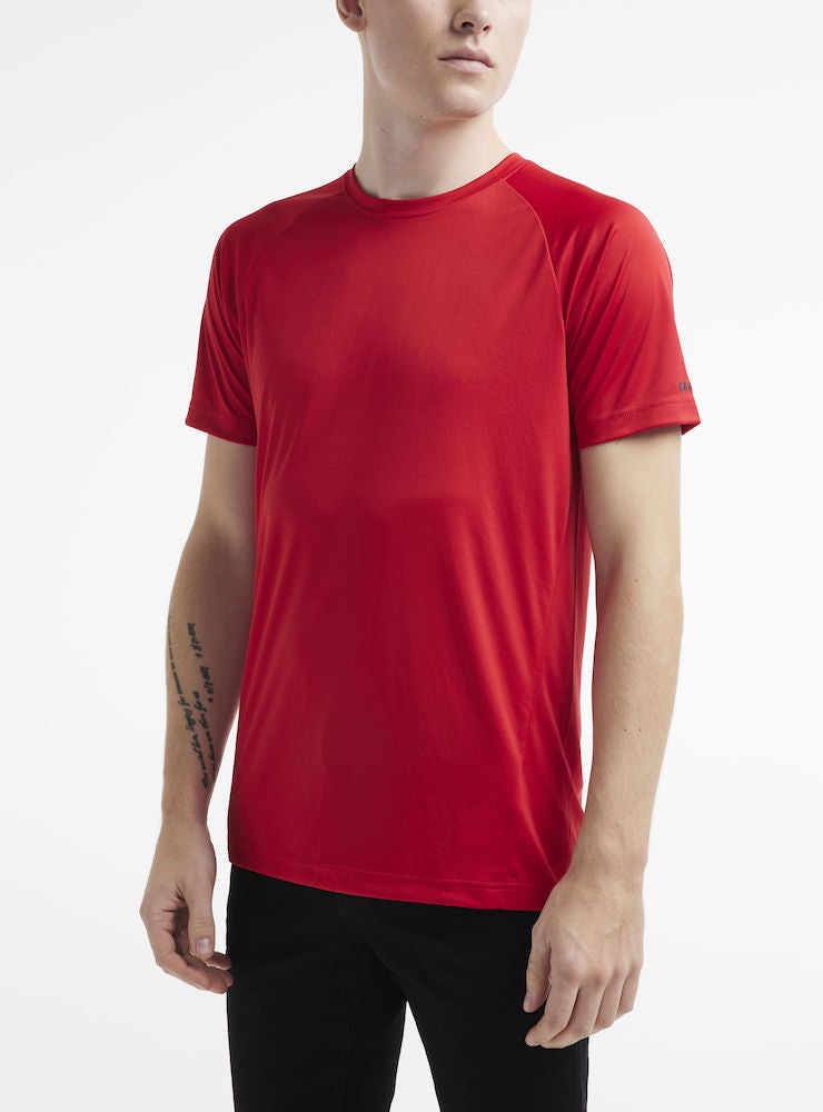 Man models a red athletic t-shirt with short sleeves and a simple crew neck.