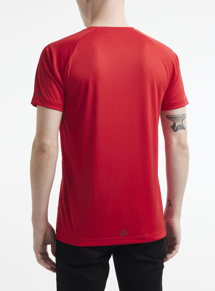 Man models a plain red athletic t-shirt, showcasing the back view.