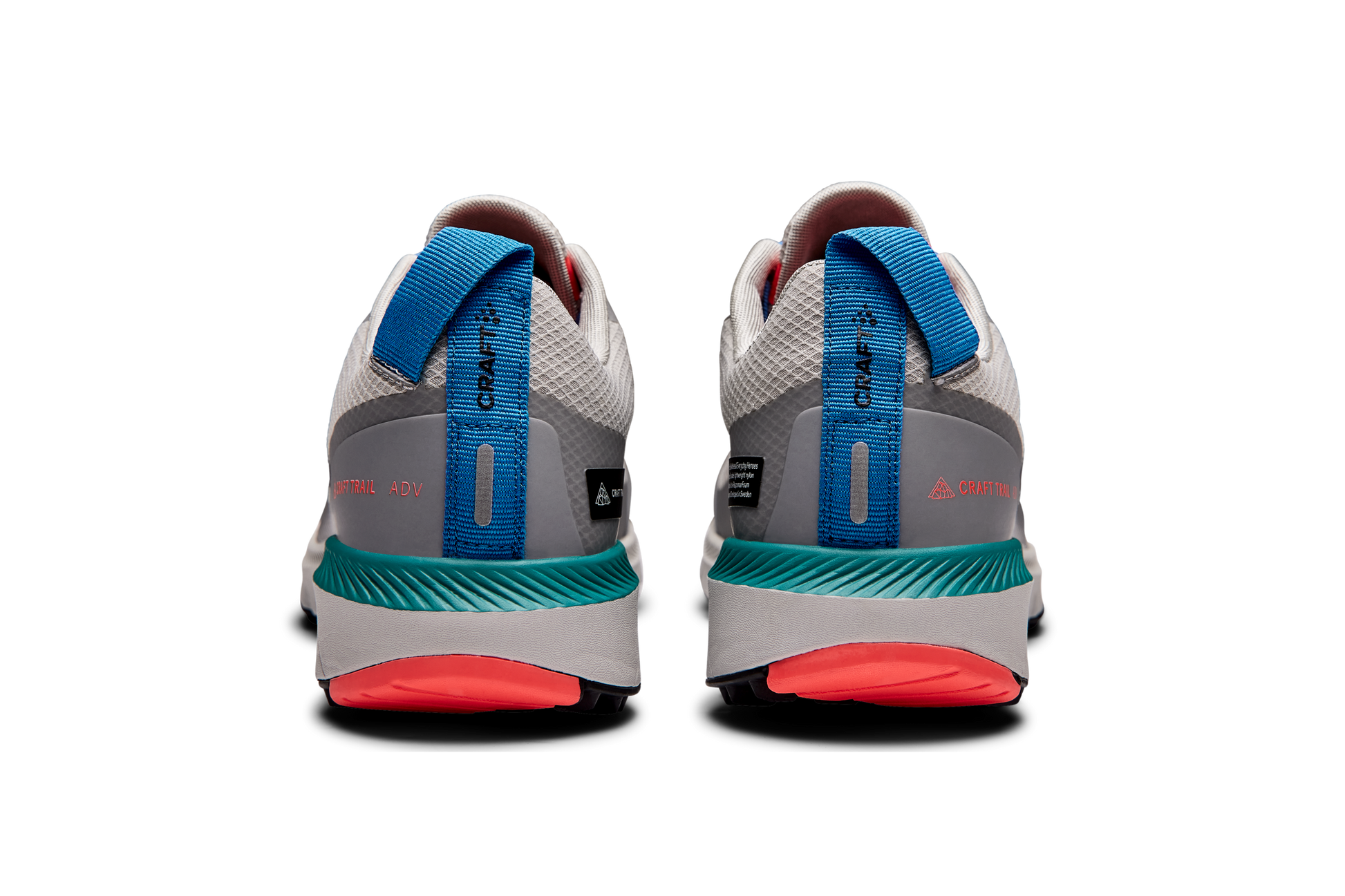 Rear view of gray Craft Trail ADV running shoes, featuring teal cushioned soles and bright coral accents.