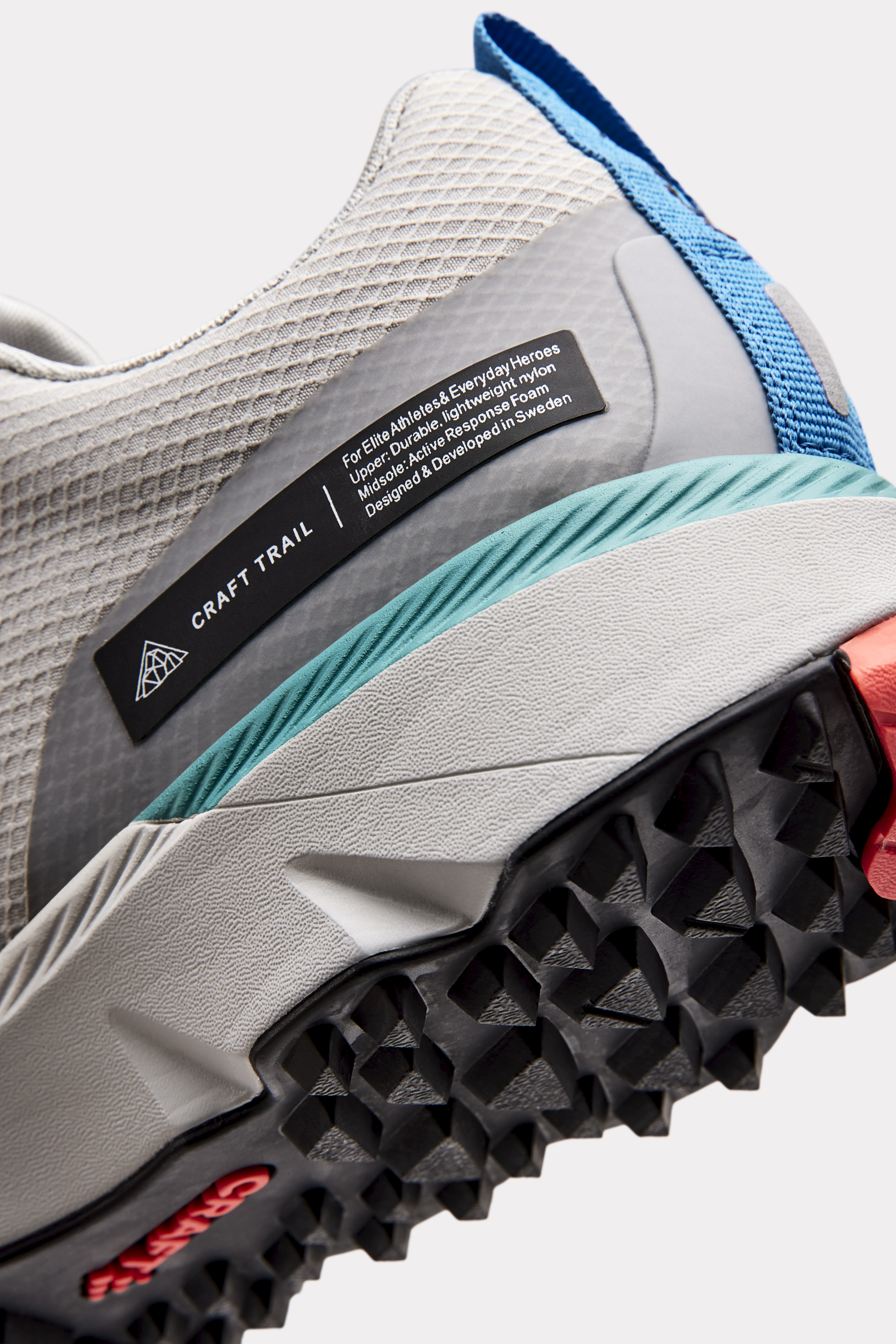 Close-up of Craft Trail running shoe, highlighting the durable lugged outsole and breathable gray nylon upper.
