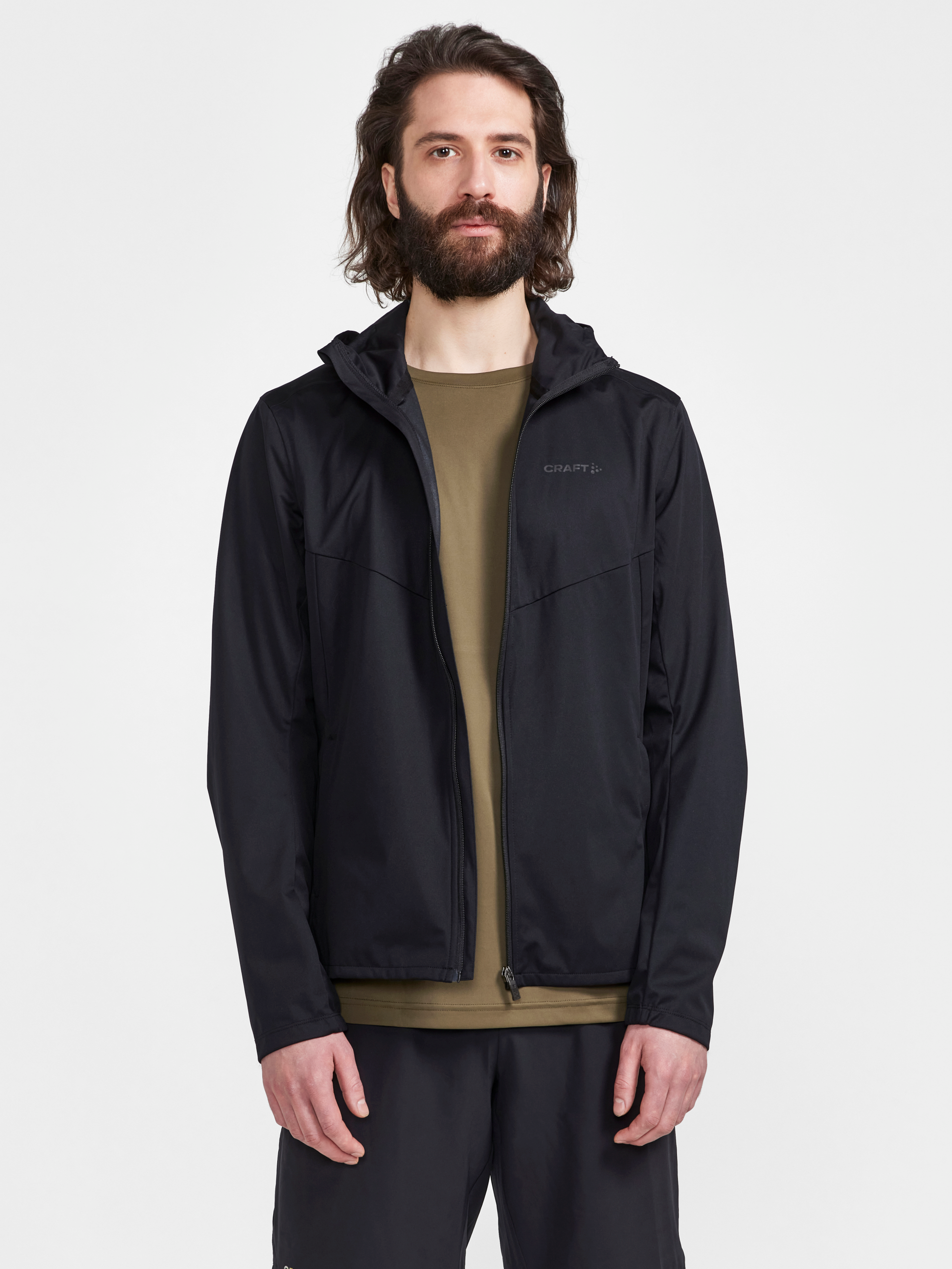 Man models a black zip-up athletic jacket with hood.