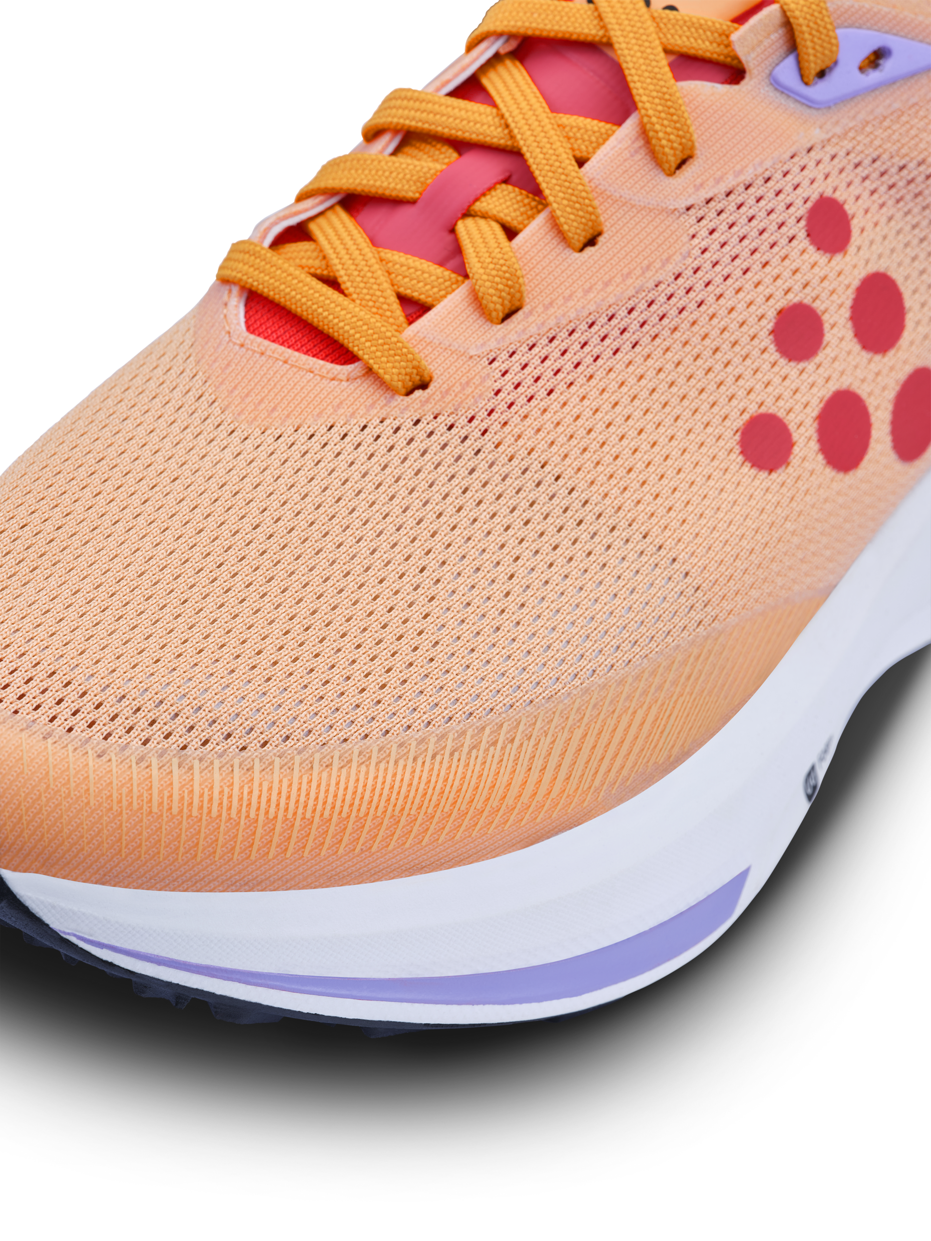 Close-up of a peach-colored running shoe with bright orange laces and a breathable mesh upper.