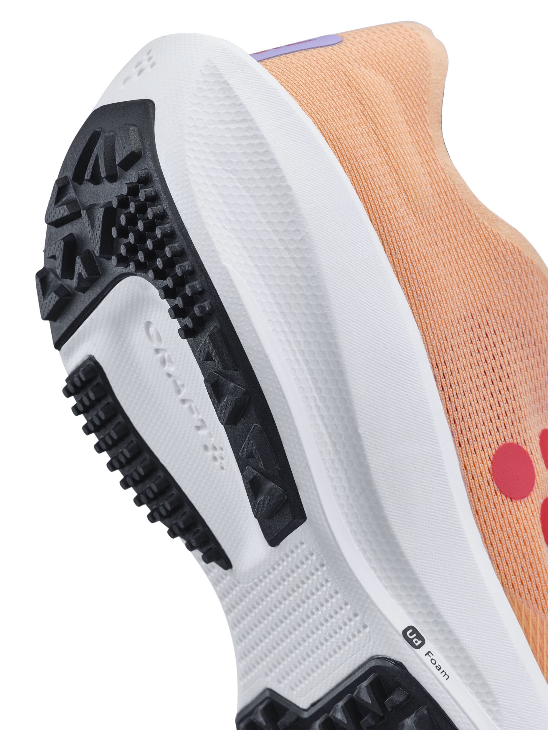 Close-up of the On Running shoe's outsole, showcasing the CloudTec® cushioning technology and durable rubber tread pattern.