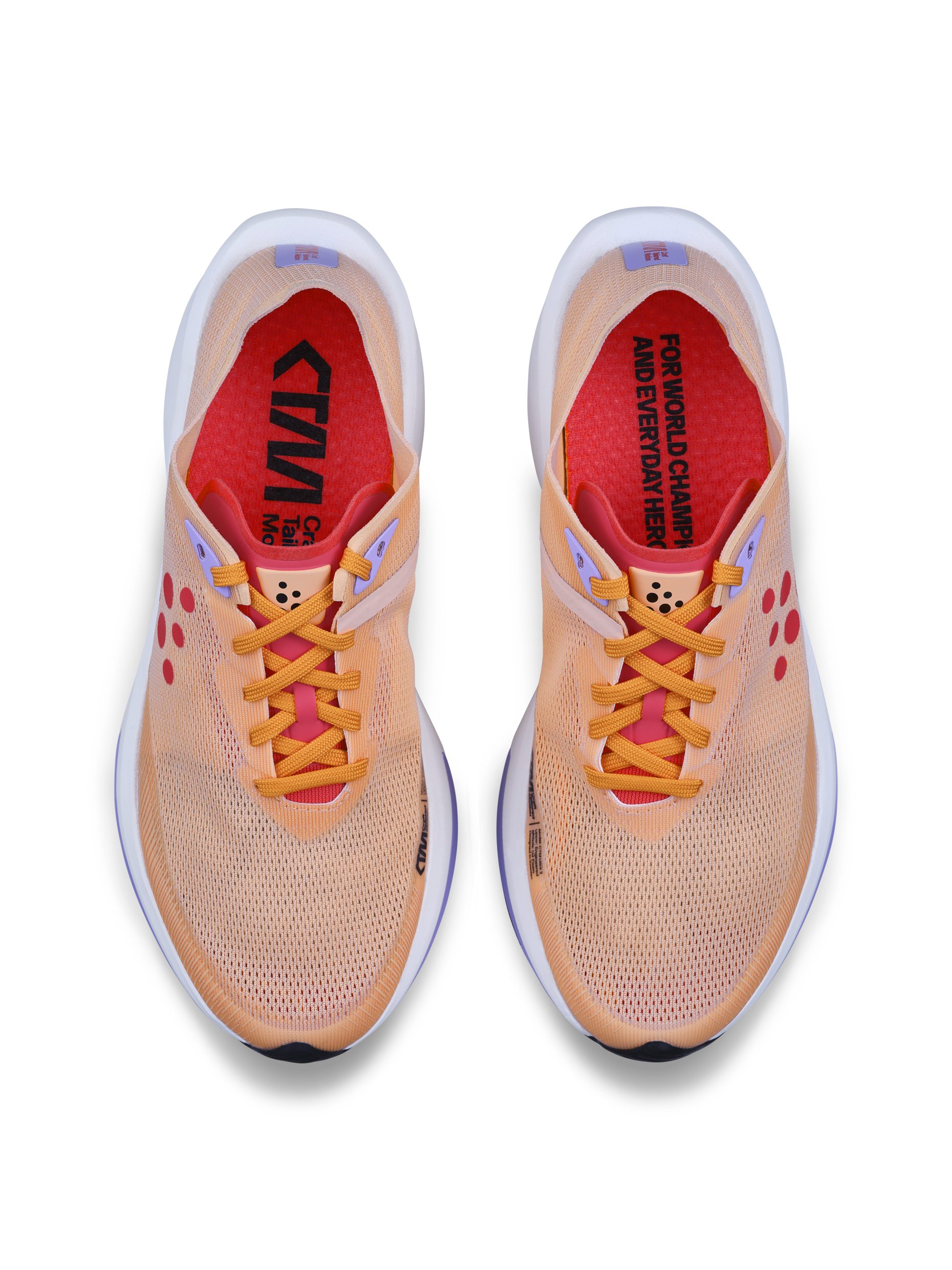 Pair of peach running shoes with bright orange laces and red insoles, shown from above.