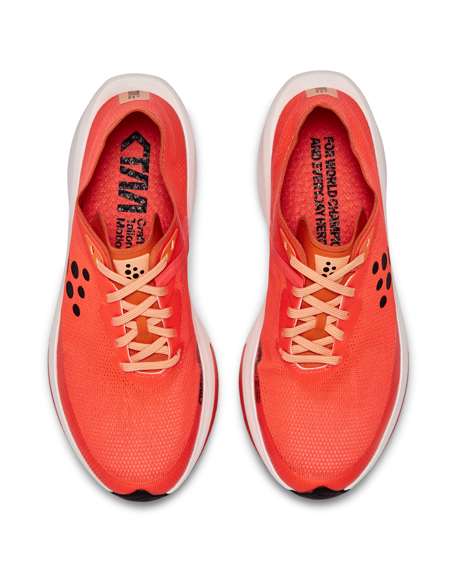 Pair of bright red Craft Motion running shoes with peach laces, viewed from above.