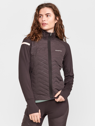 Woman models a brown athletic jacket with chevron quilting and a front zipper.