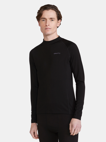 Man models a black long-sleeve base layer top with a mock neck collar.