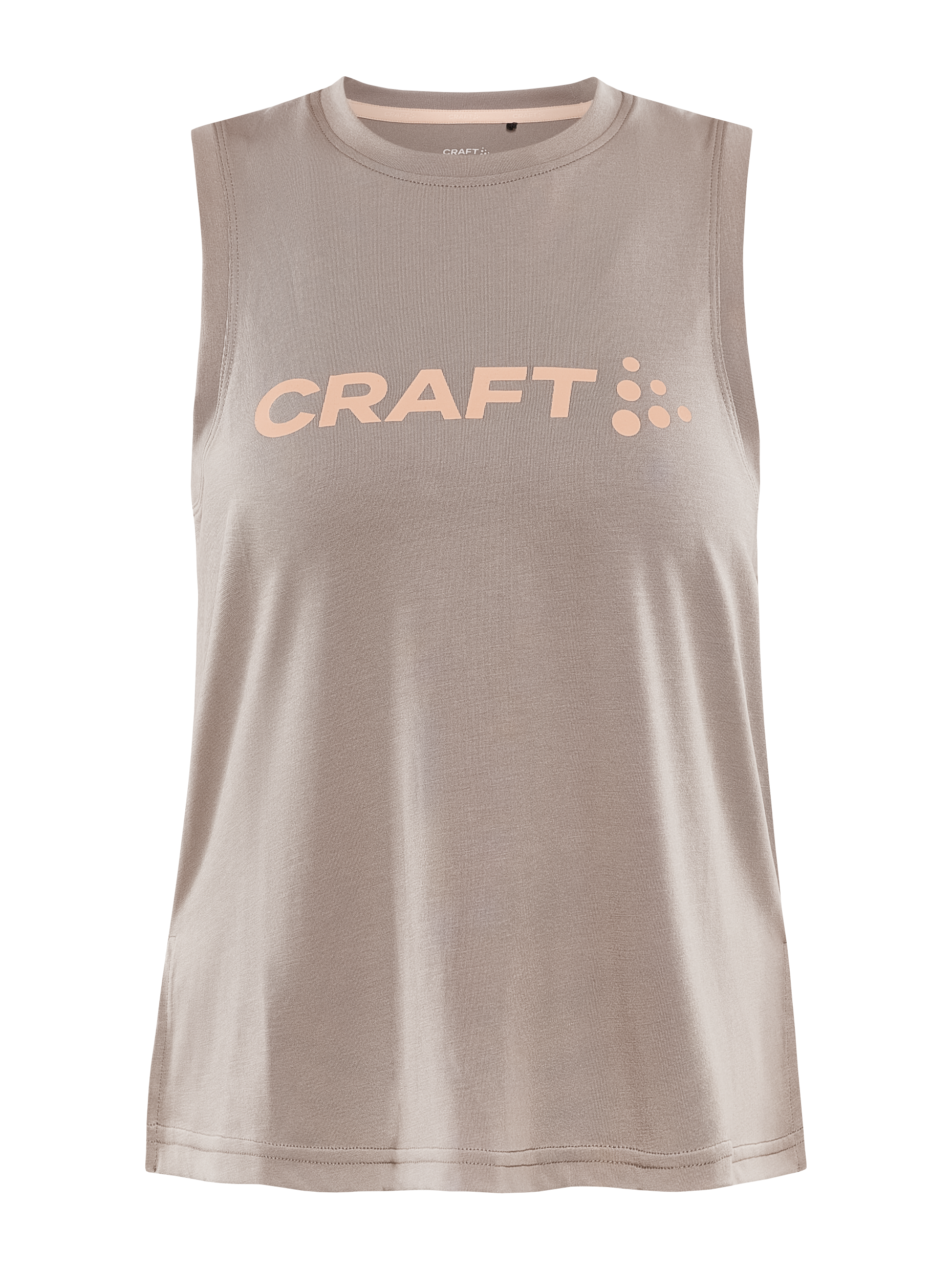 A dusty pink Craft sleeveless workout shirt lays flat, showcasing the peach Craft logo across the chest.