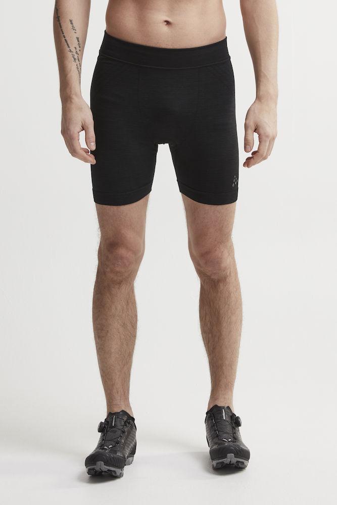 Man models black athletic compression shorts for running or training.