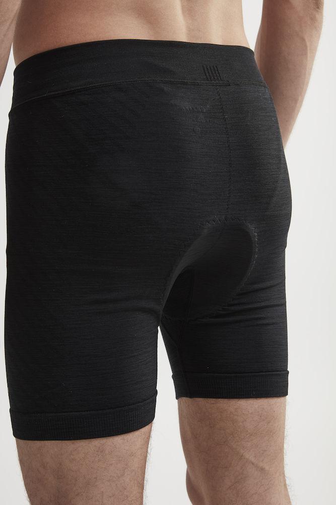 Man models black athletic boxer briefs with chamois padding.