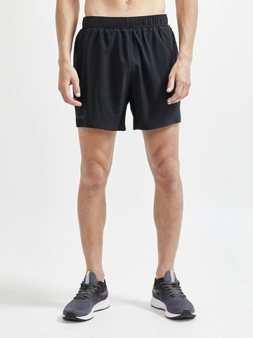 Man models black athletic shorts for running.