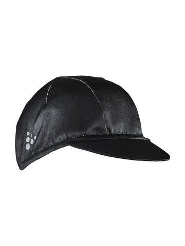 A black cycling cap with a small brim shields a rider's head from the sun.