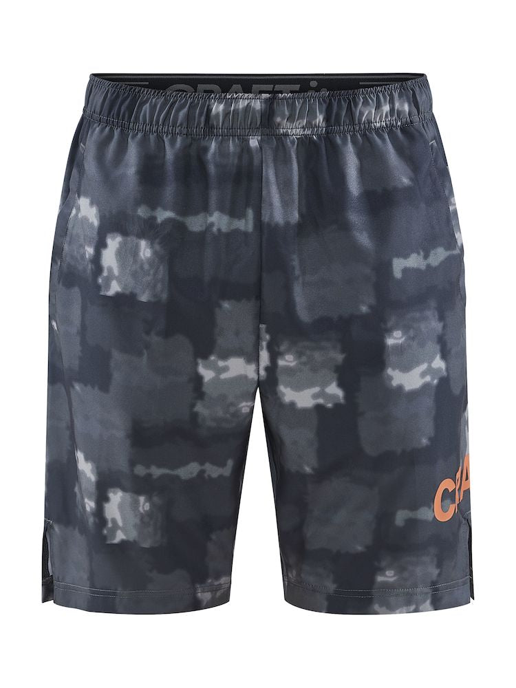 Men's Craft gray camo athletic shorts with orange logo.