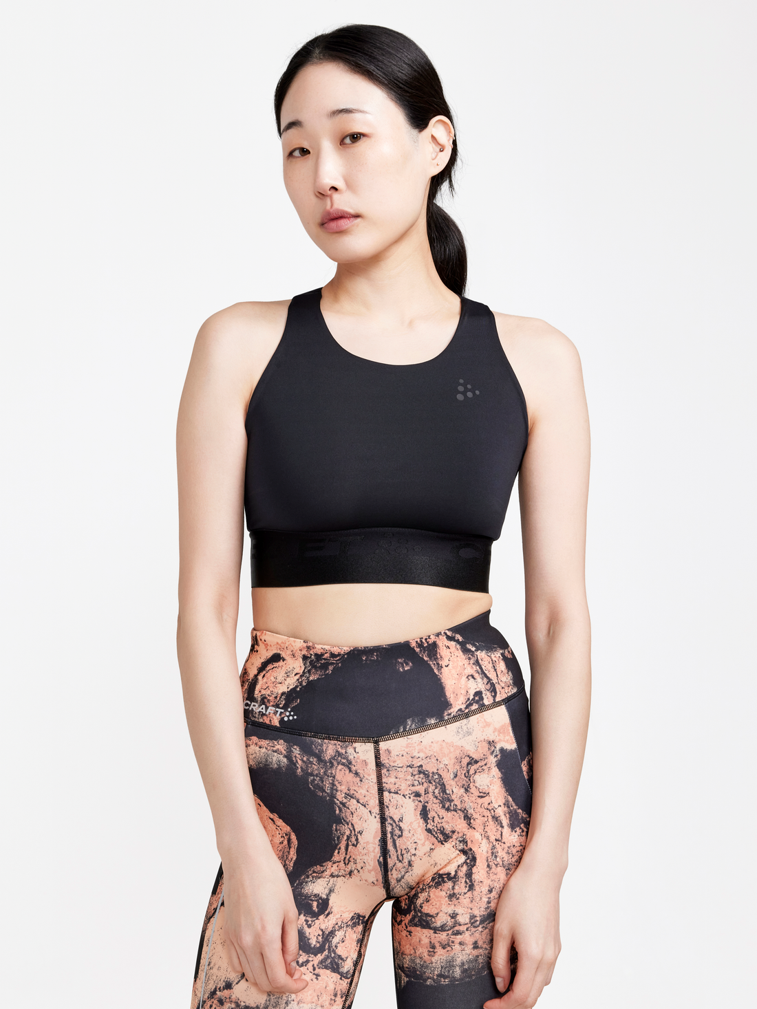 Women with black vest top wearing multicoloured tights