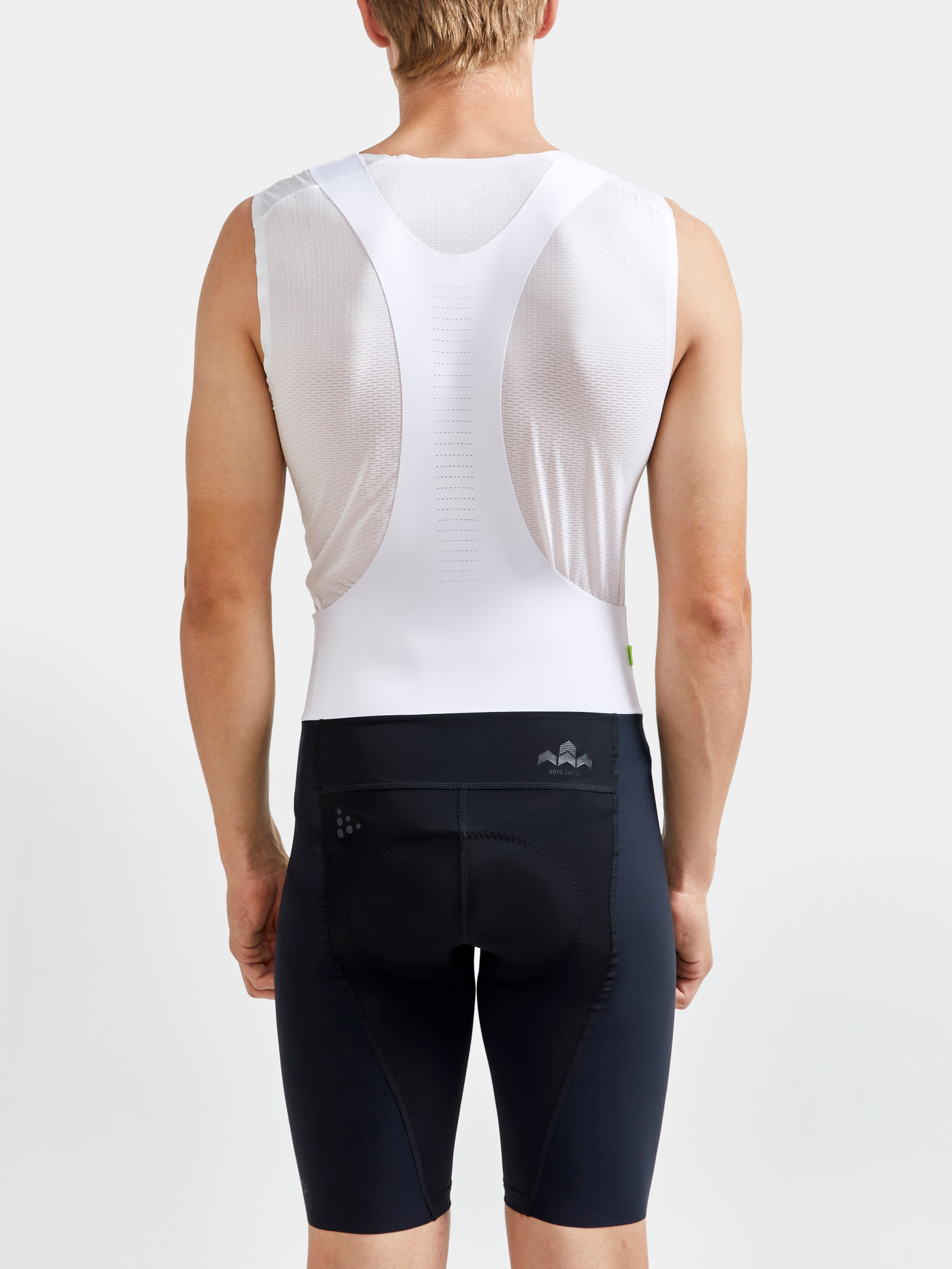 Cyclist models black cycling bib shorts with back turned.