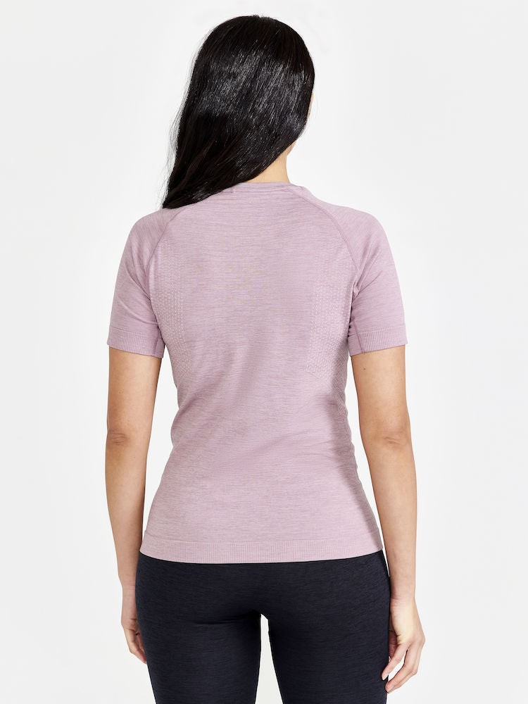 Woman models a lightweight, breathable, mauve athletic t-shirt from the back.