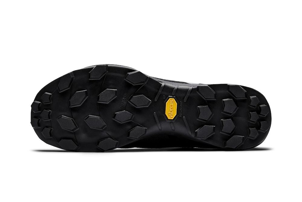 Black hiking shoe sole featuring Vibram Megagrip tread for superior traction.