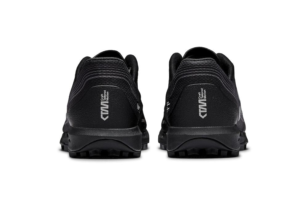 Rear view of black running shoes highlighting the "Crafted Tailored Motion" detail on the heel.