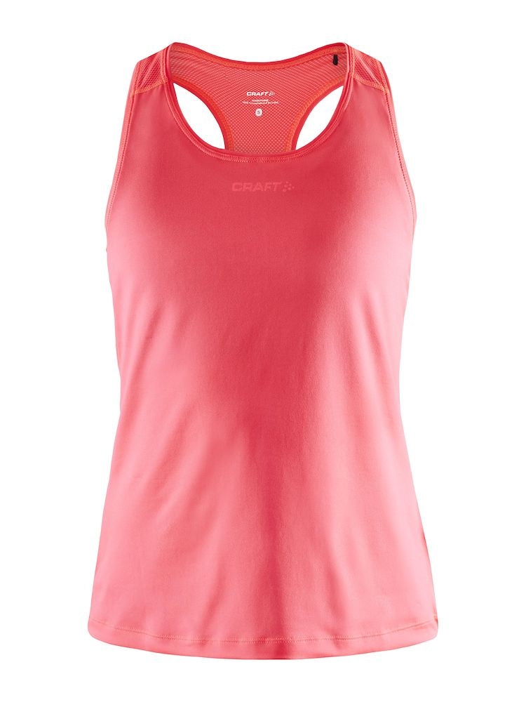 Woman models a coral pink Craft® athletic tank top and black running tights. 

