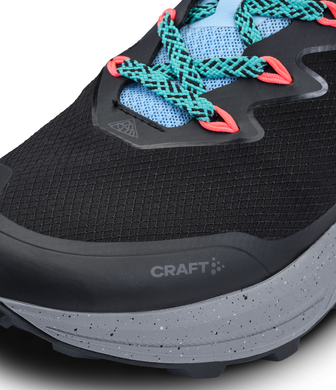 Black Craft trail running shoe with speckled gray sole and bright orange and teal accents. 
